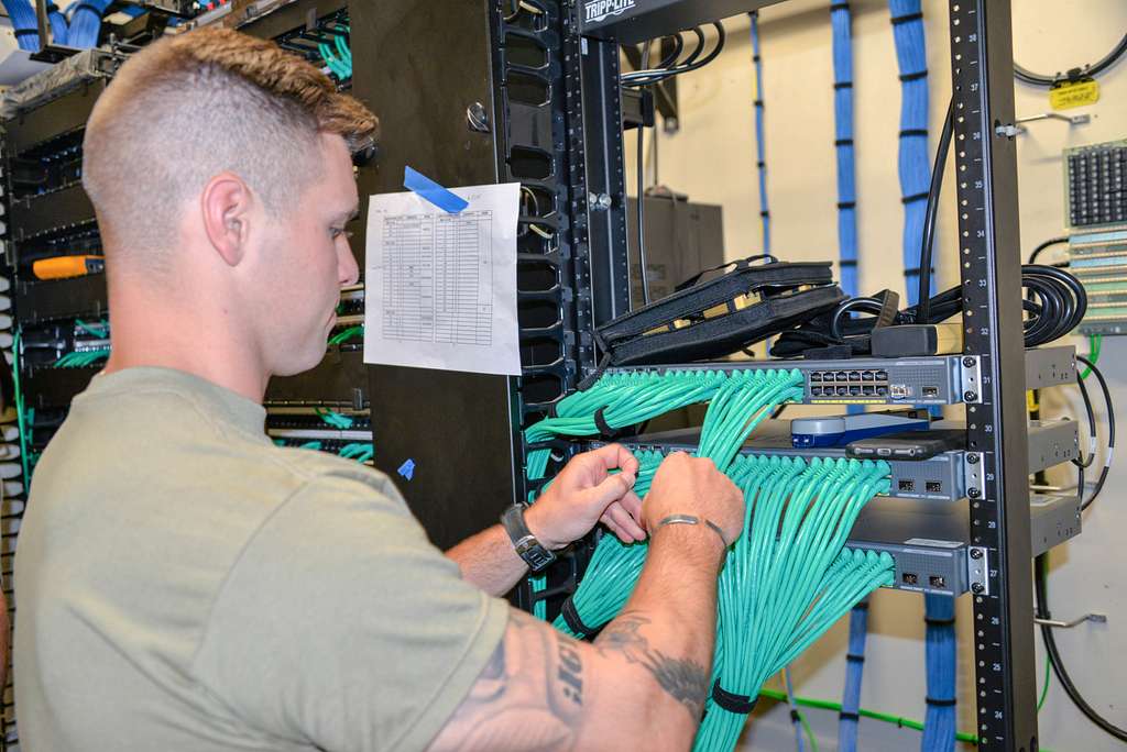 Network cabling installer working on a network switch